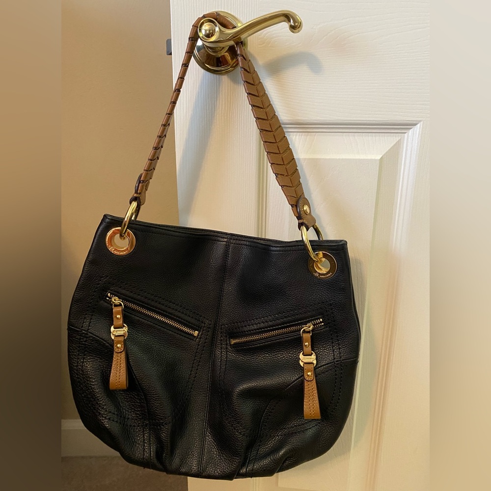 B. Makowsky black leather handbag with Brown leather strap.